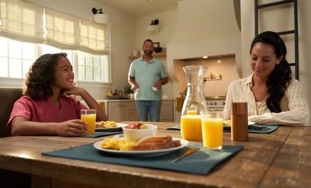 Family at the dining table eating breakfast.