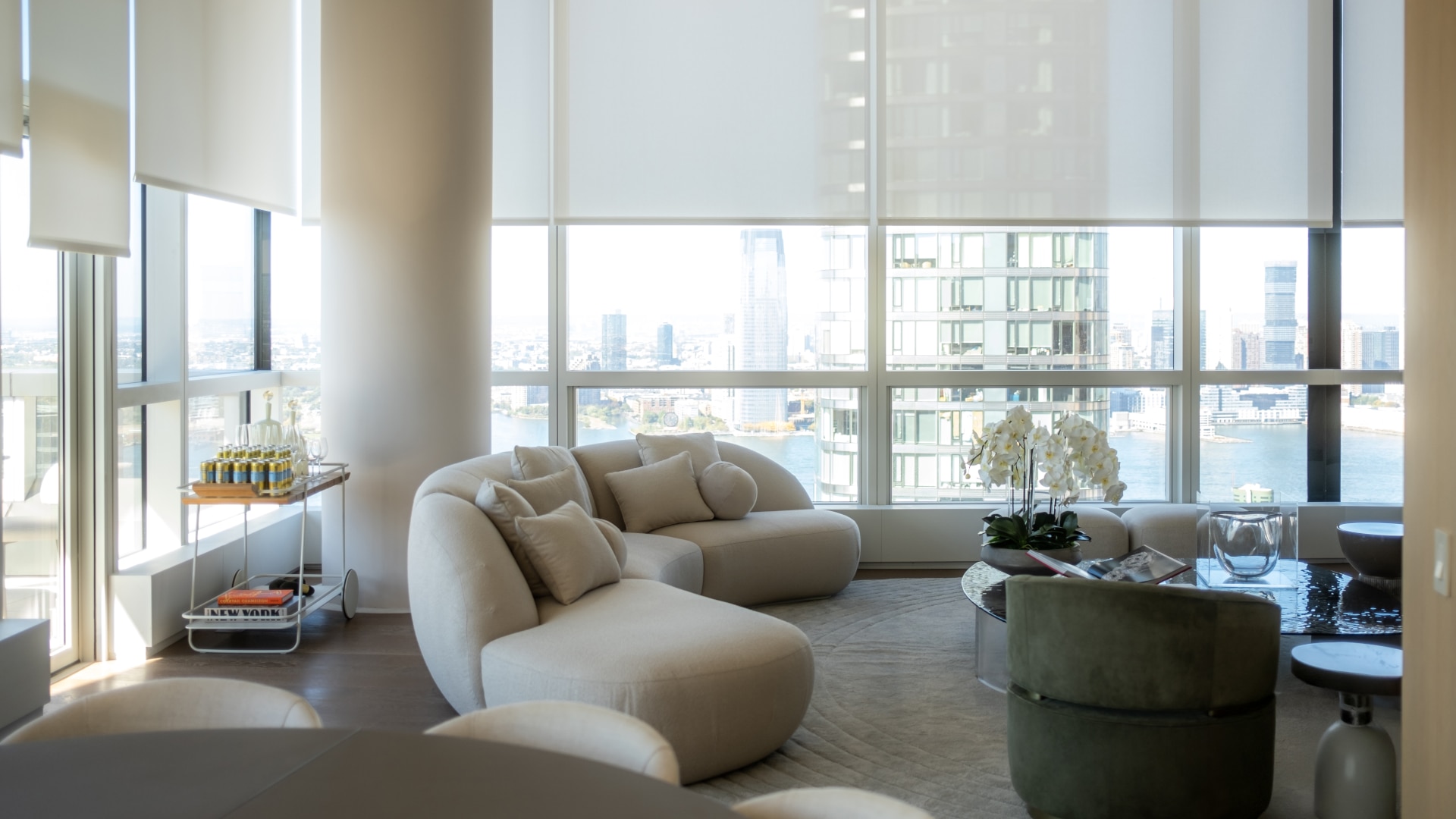 Modern living room with high windows overlooking a winter outdoors scene.
