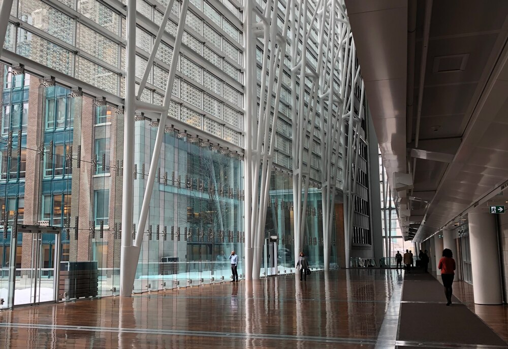 Looking out the windows of a hallway within the building.