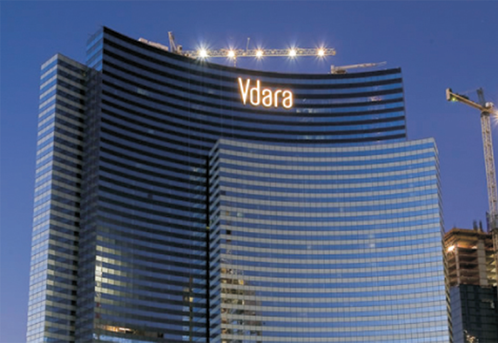 Exterior image of the MGM City Center Vdara building as night falls over Las Vegas.