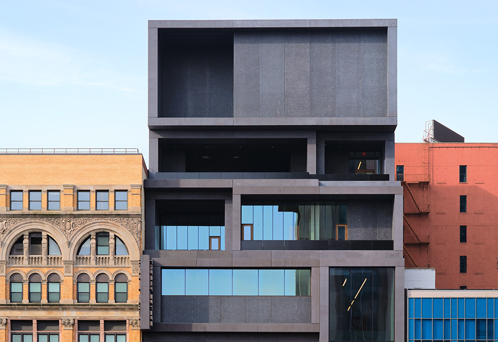 Front facing shot of the Studio Museum in Harlem showcasing a modern design with dark gray coloring and rectangular shapes.